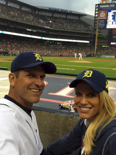 Jim ja Sarah Harbaugh yllään maissi- ja siniset Tigers-hatut. (Twitter/@coachjim4um)