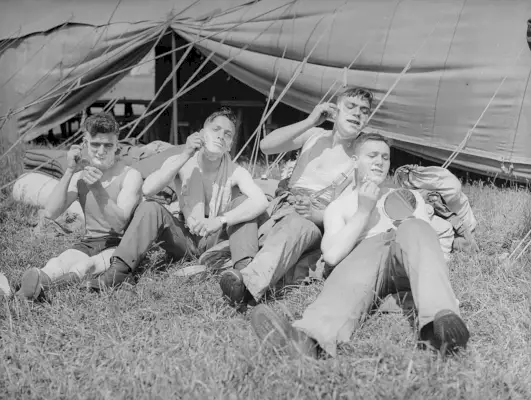 Kesäkuu 1935: Territoriaalisen armeijan 26. panssariautokomppanian jäsenet parrahtelevat leirin aikana Cayton Bayssä.