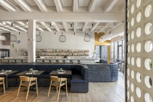 ruokailuhuoneen sisustus, jossa on puiset kattopalkit ja siniset istuimet